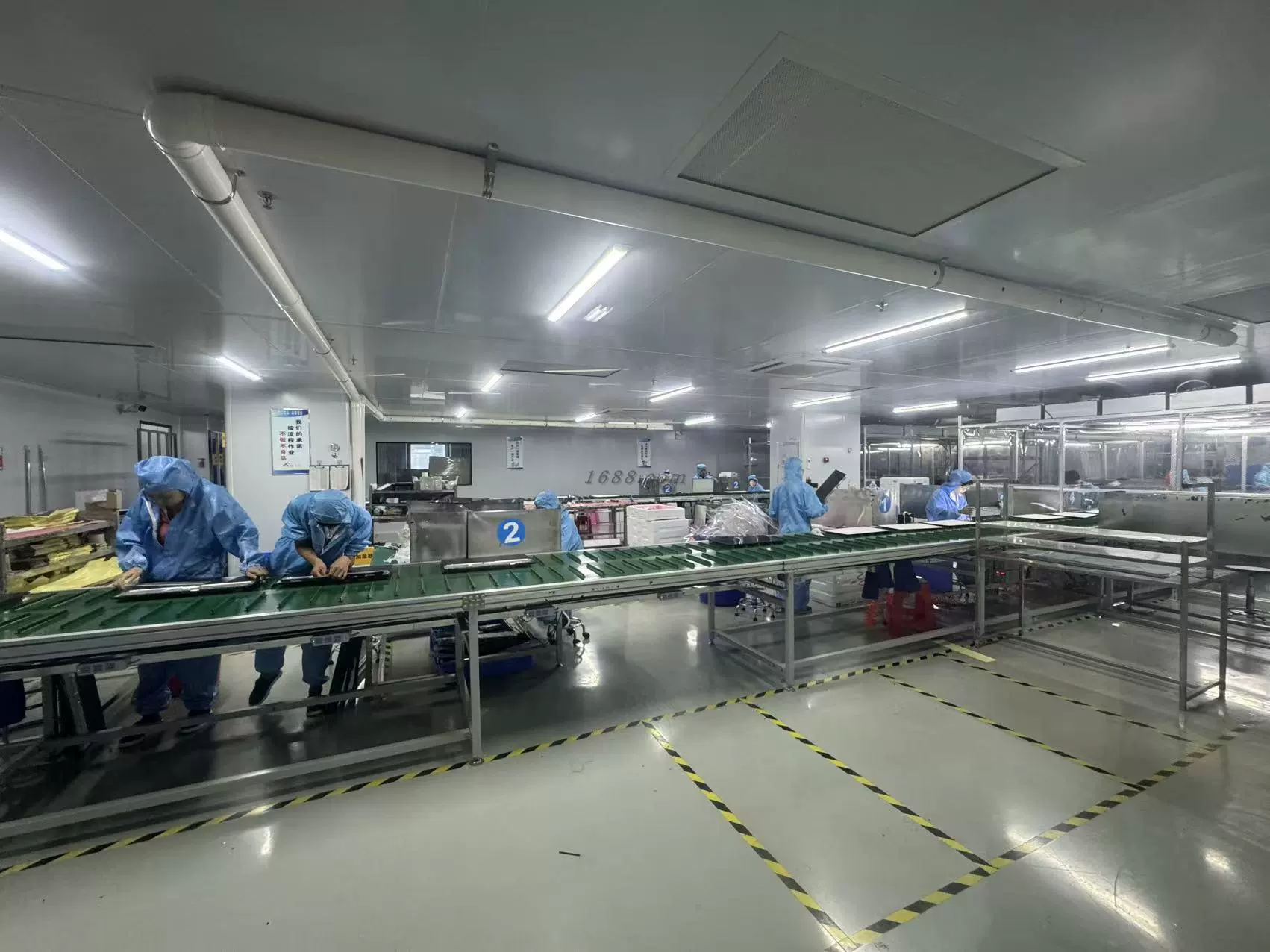 Clean production area with technicians working on display assemblies